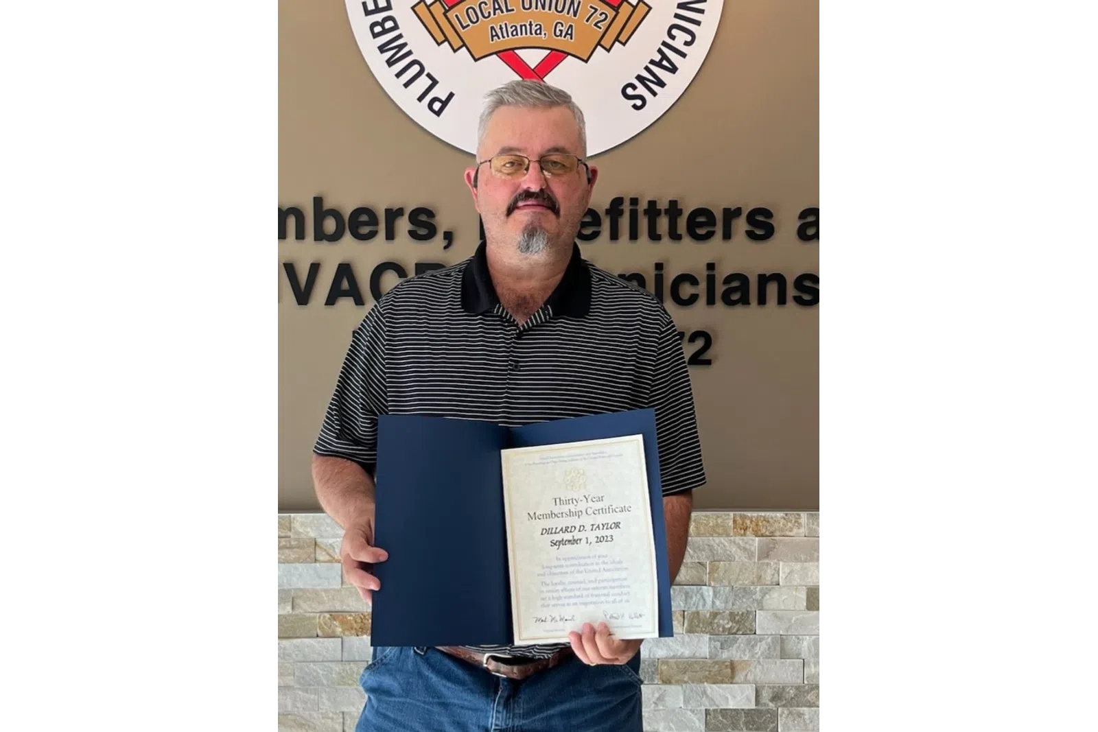 a man holding a certificate