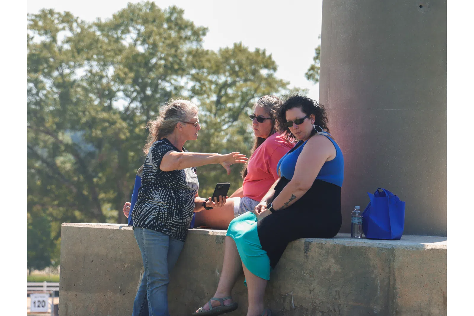 a group of people sitting on a ledge