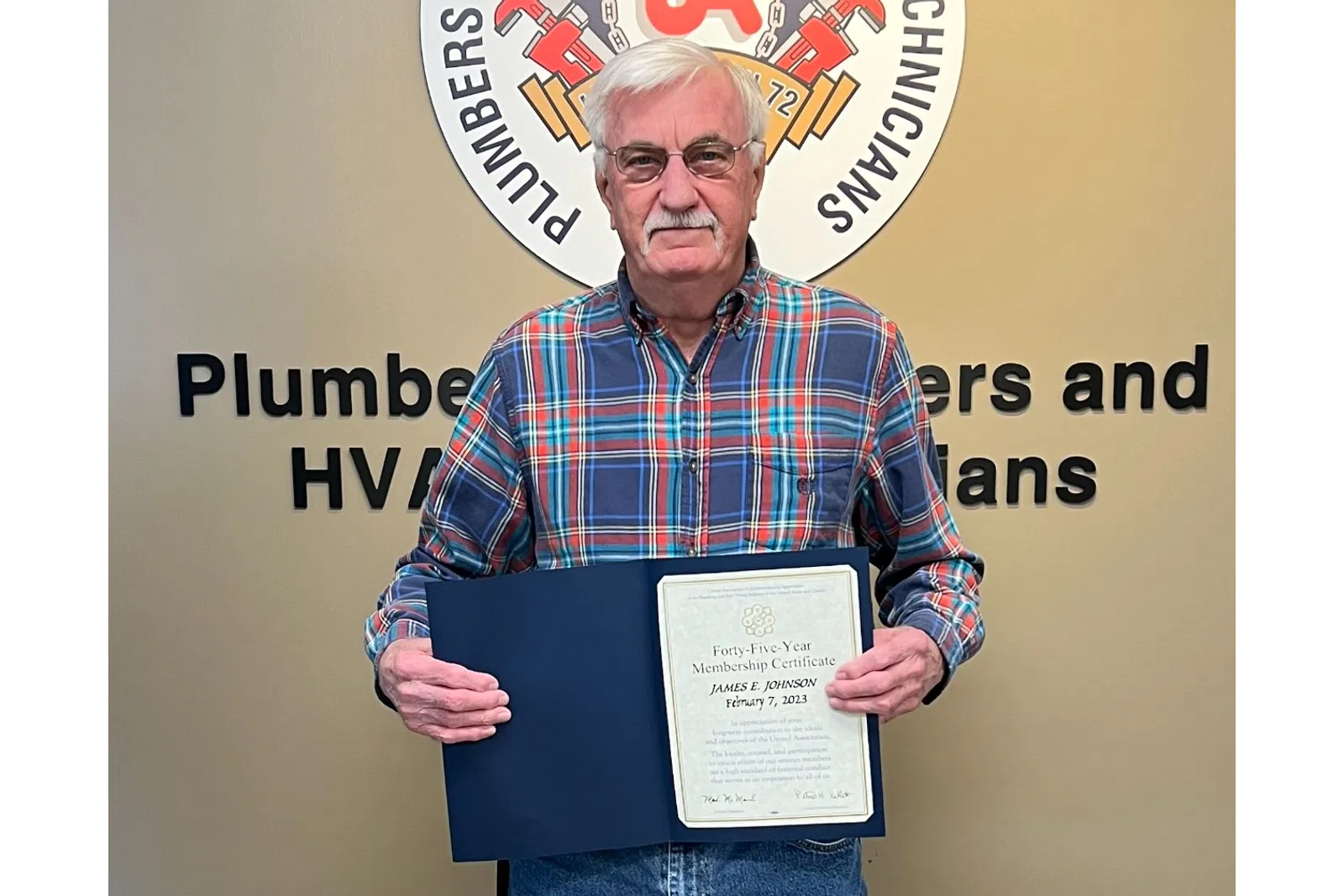 a man holding a certificate