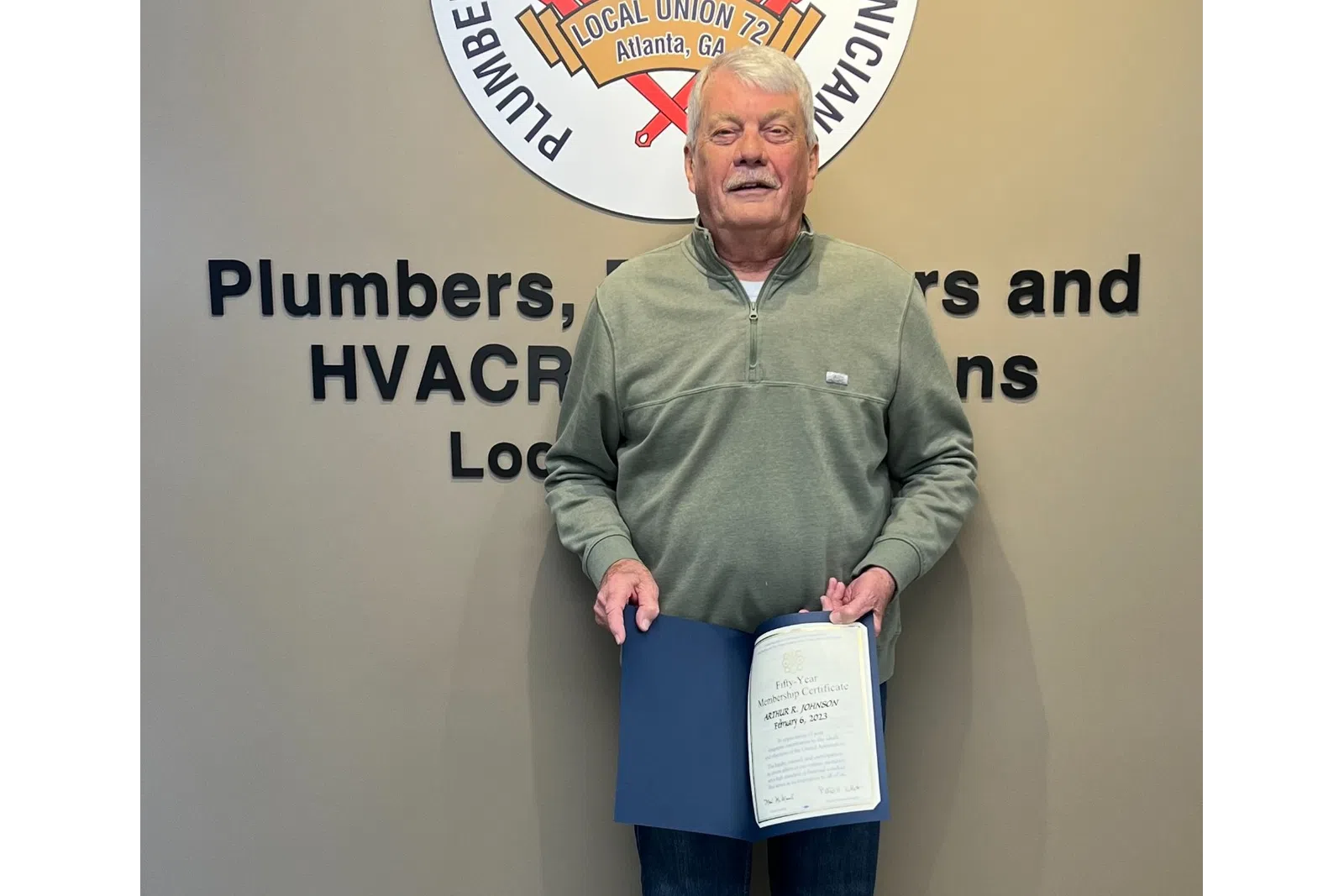 a man holding a certificate