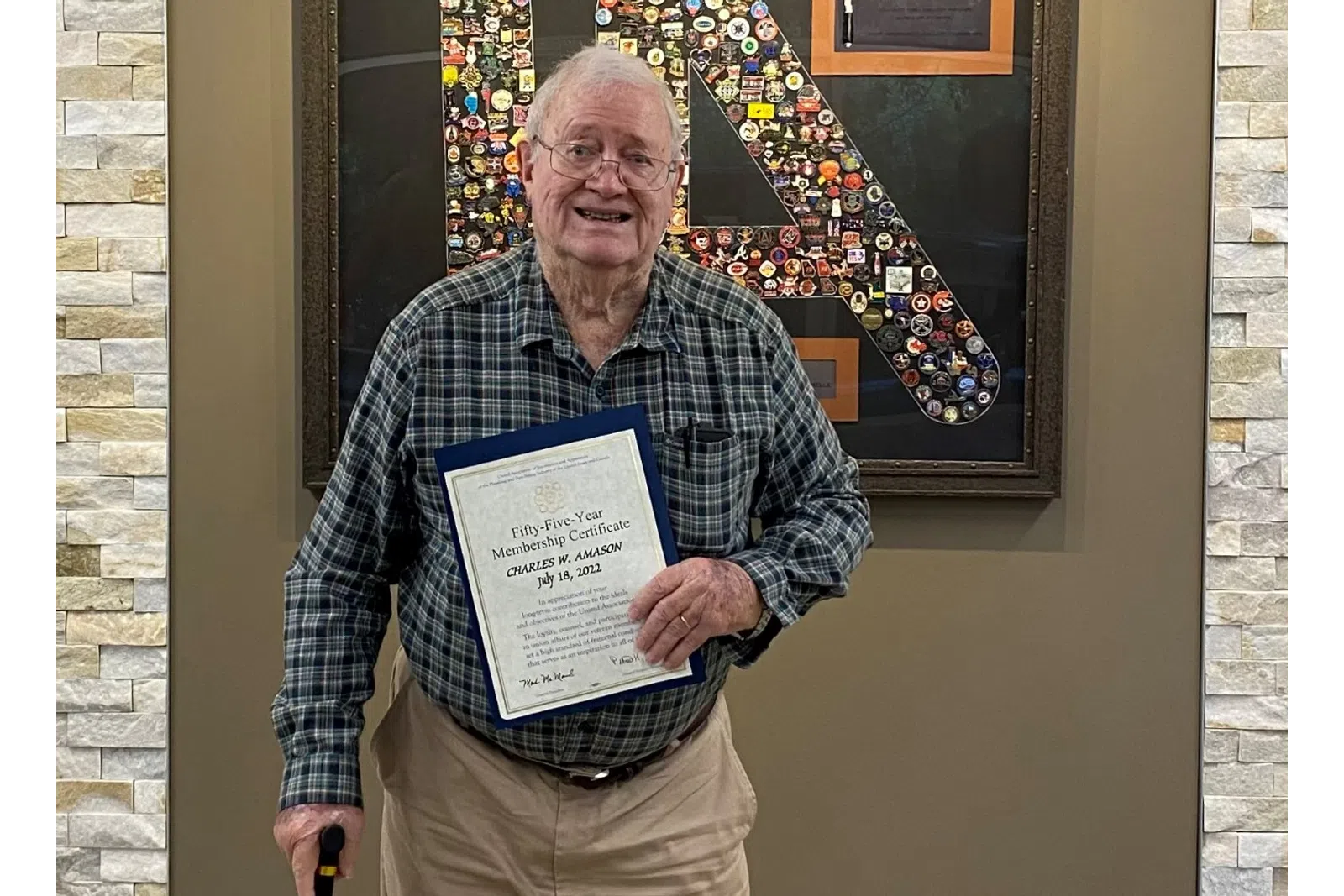 an old man holding a sign