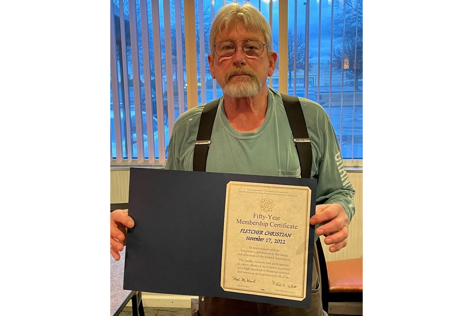 a man holding a certificate