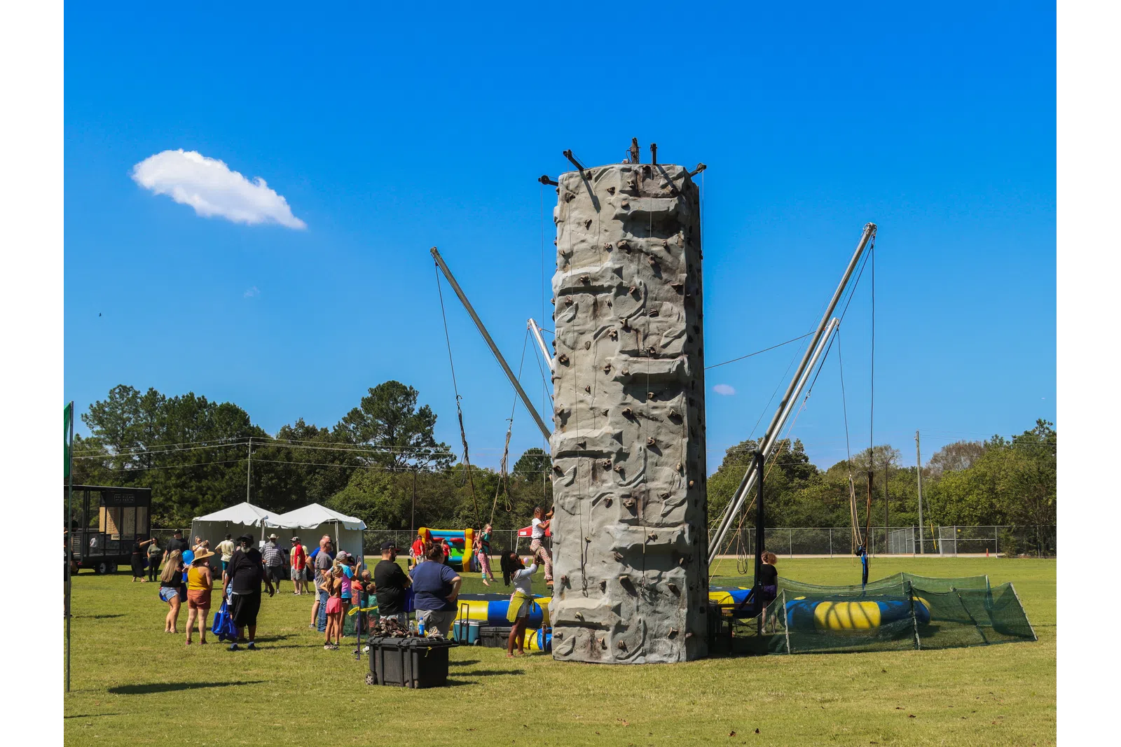 a stone monument with people around it