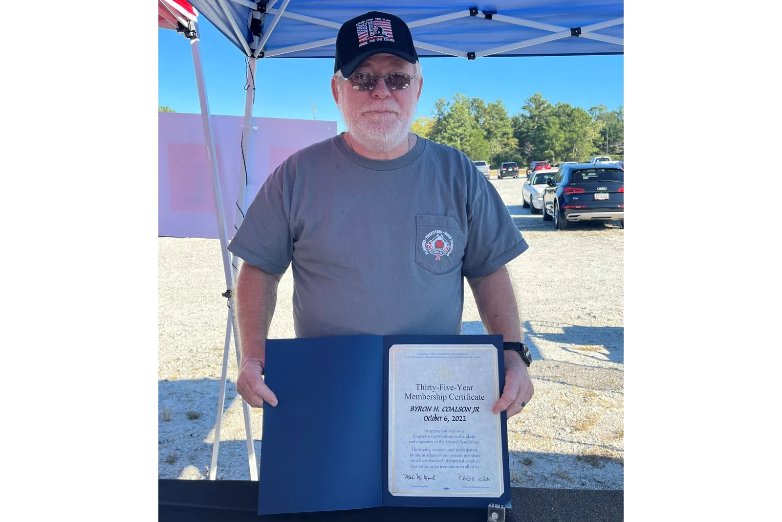a man standing next to a sign