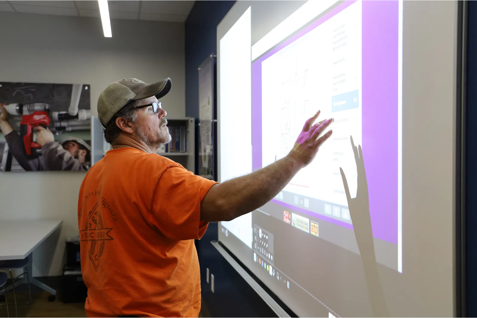 a man pointing at a screen