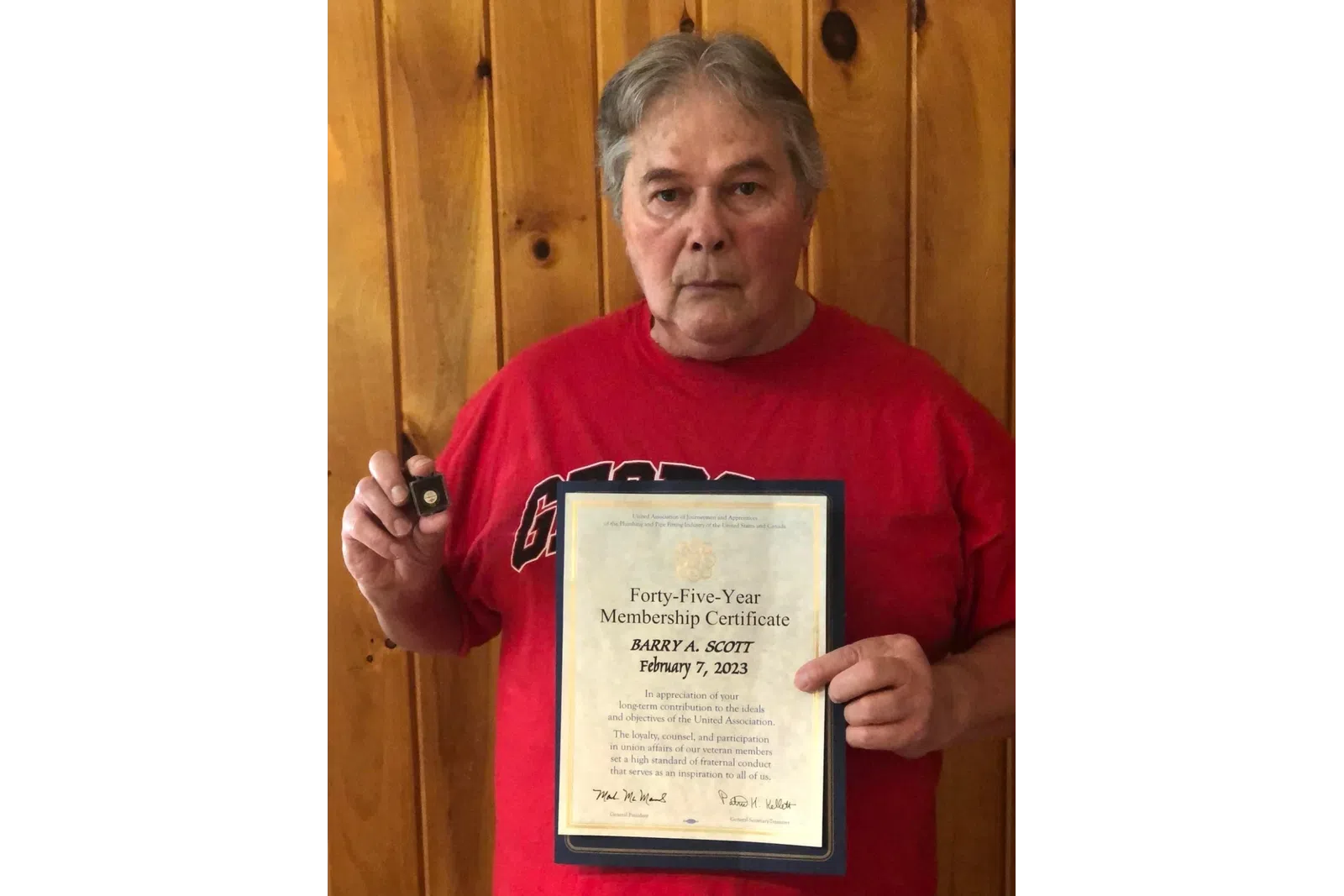 a man holding a certificate