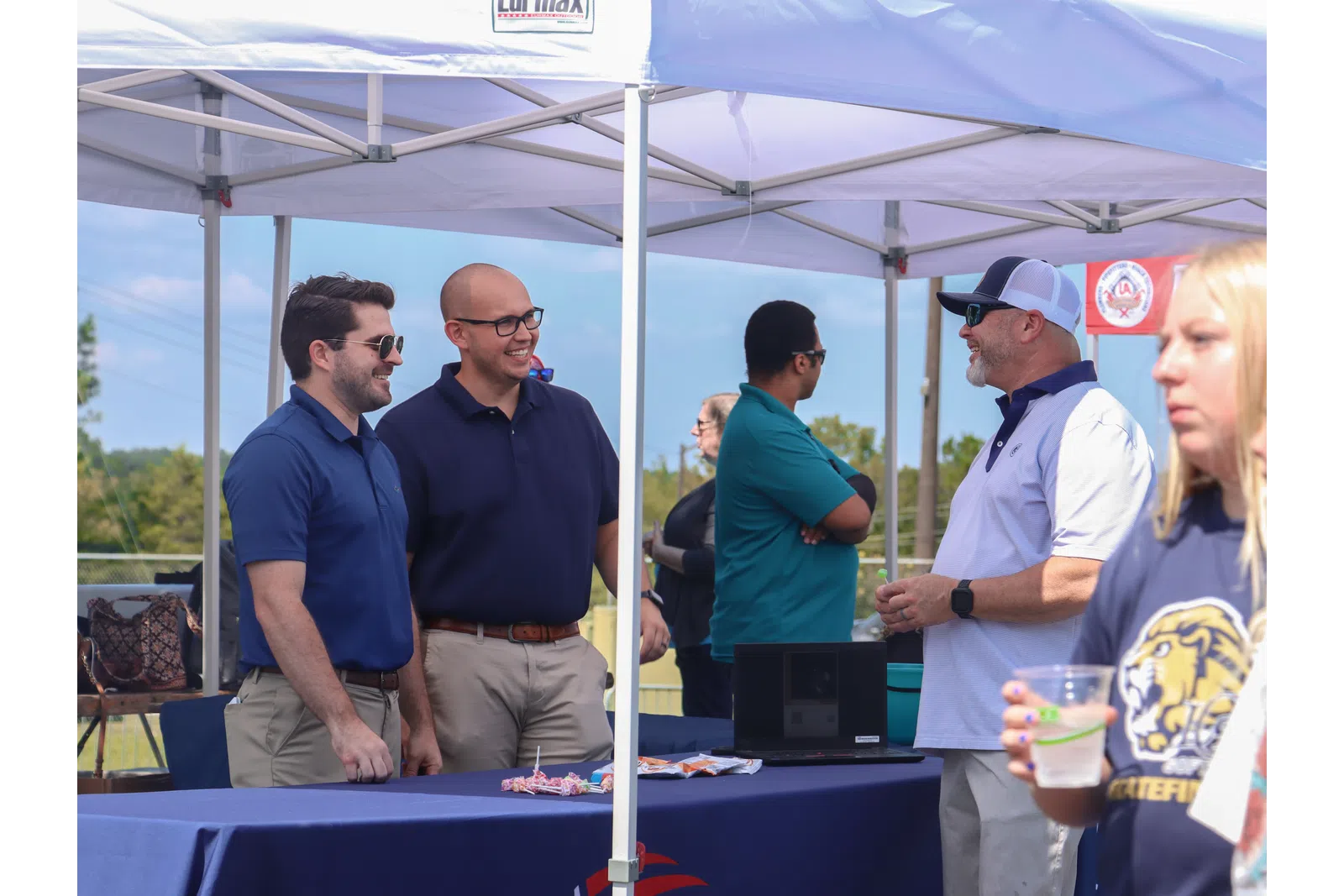 a group of people standing under a tent