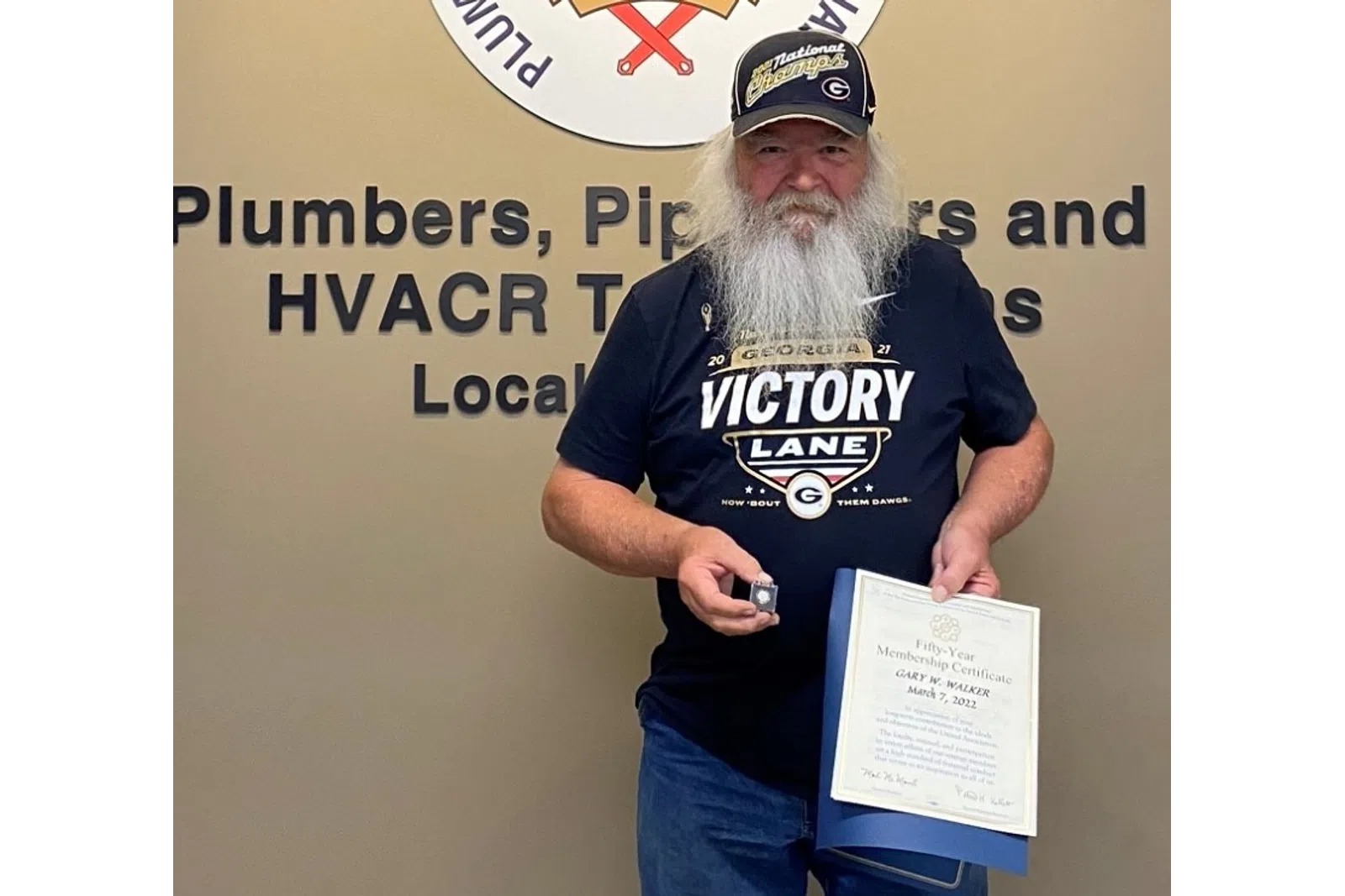 a man holding a certificate