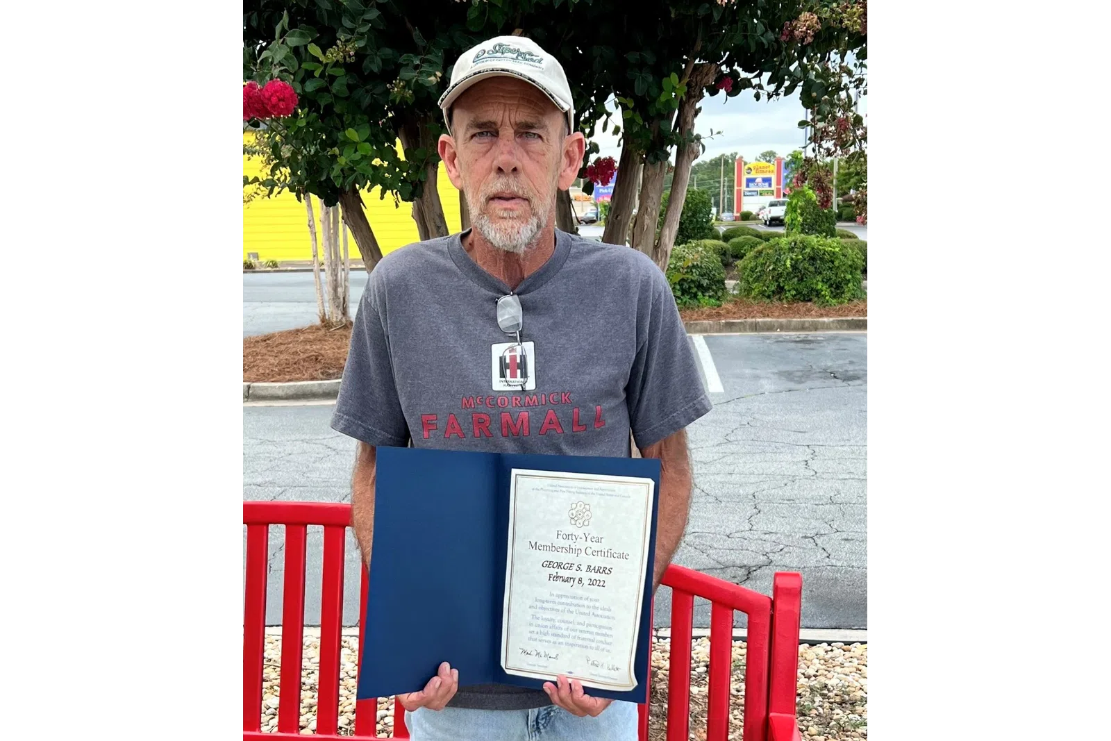 a man holding a certificate
