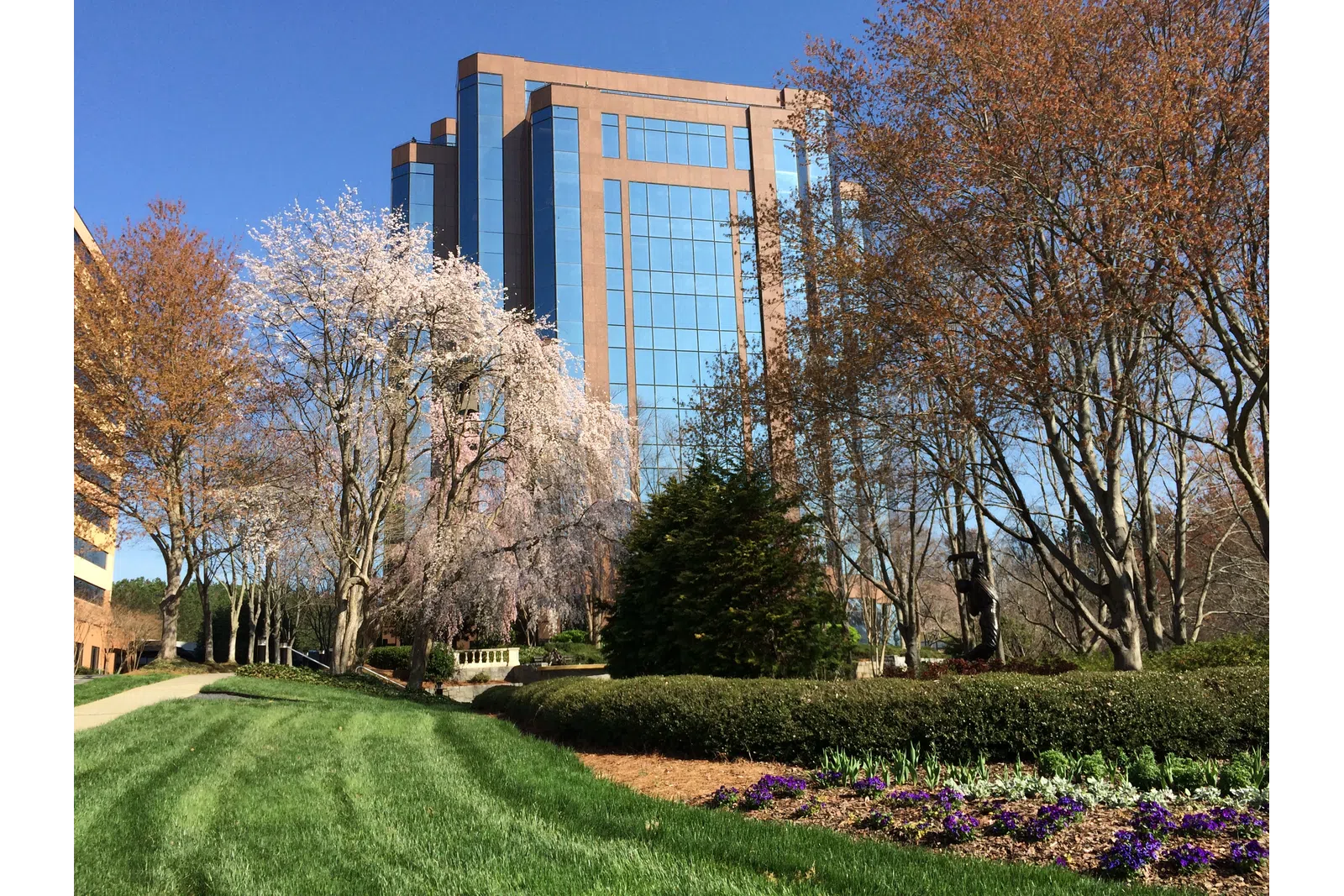 a building with trees and grass