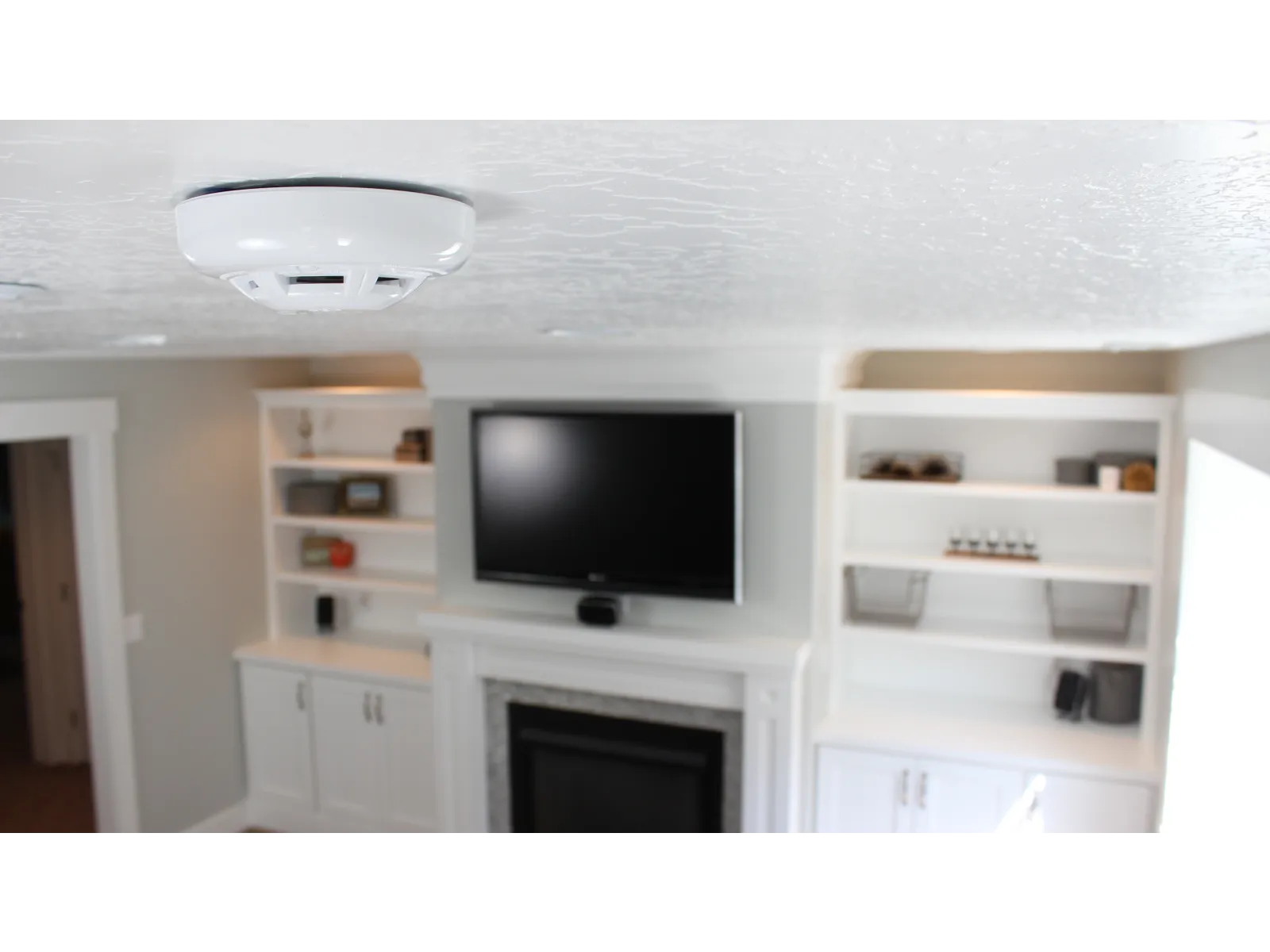 a room with a television and shelves