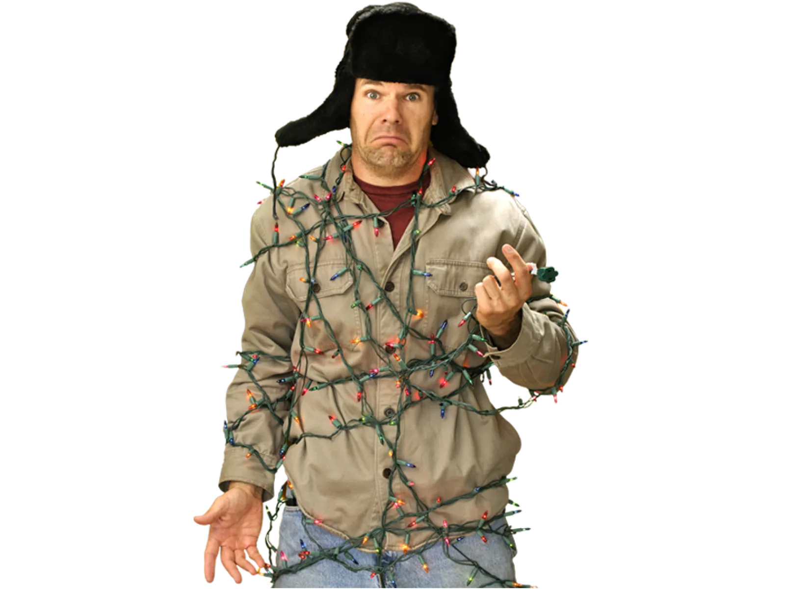 Man wearing a winter hat tangled in colorful Christmas lights with a confused expression.
