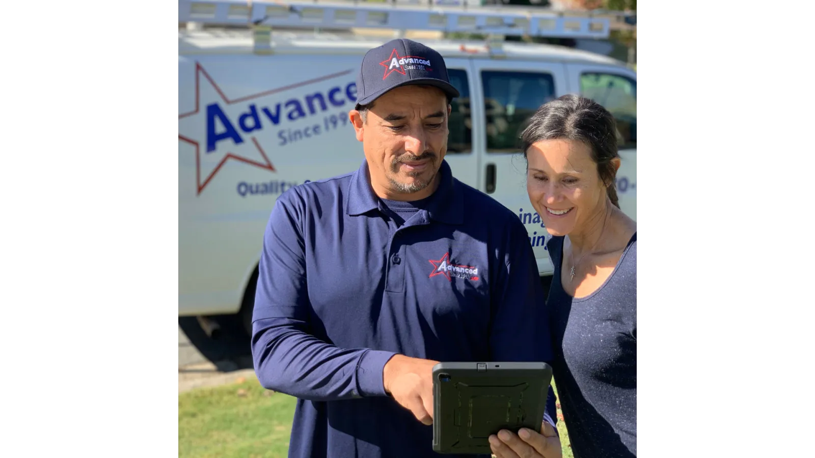 a man and woman holding a tablet