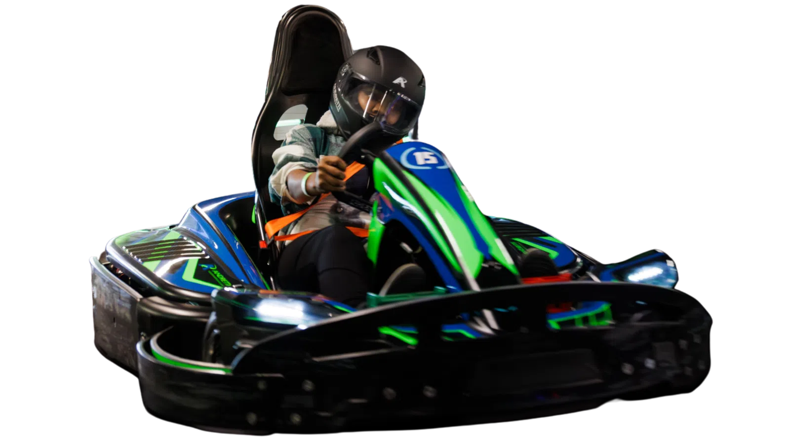 Person wearing a helmet driving a blue and green go-kart racing vehicle at speed indoors.