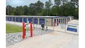 a fenced off area with a blue gate and a sign