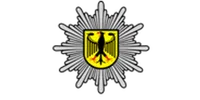 Federal Police emblem with a golden eagle on a yellow shield, radiating starburst design.