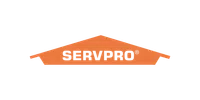 Orange SERVPRO logo shaped like a house roof with black text on black background