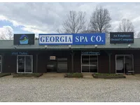 Exterior of Georgia Spa Co. building with signs for hot tubs, cold plunge, and employee-owned company.