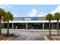 Front view of Georgia Spa Co. storefront with palm trees and clear blue sky on a sunny day