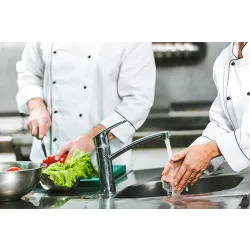 a man cooking in a kitchen preparing food