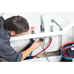 a man standing next to a sink