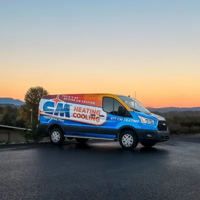 CM Heating and Cooling service van parked outdoors during sunset with mountains in the background