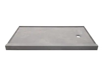 Rectangular gray stone shower base with raised edges and a circular drain hole on one side.