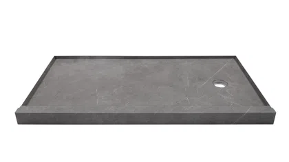 Rectangular gray stone shower base with a raised edge and round drain hole on white background.