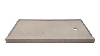 Rectangular concrete shower base with raised edges and circular drain hole on white background