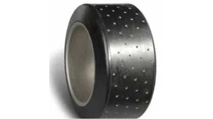 Close-up of a black perforated rubber wheel or tire with a hollow center and small circular holes.