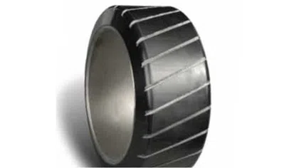 Close-up of a black tire with diagonal tread patterns on a white background.