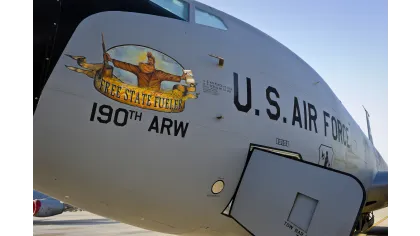Close-up of U.S. Air Force aircraft nose with Free State Fuellers and 190th ARW emblem under clear blue sky.