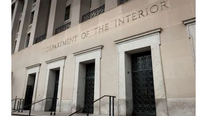 Facade of the Department of the Interior building with large doors and engraved name above.