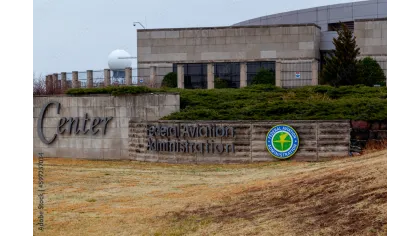 Exterior view of the Federal Aviation Administration Center with signage and surrounding greenery.