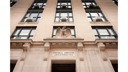 Facade of the General Services Administration building with stone eagle sculpture above entrance.