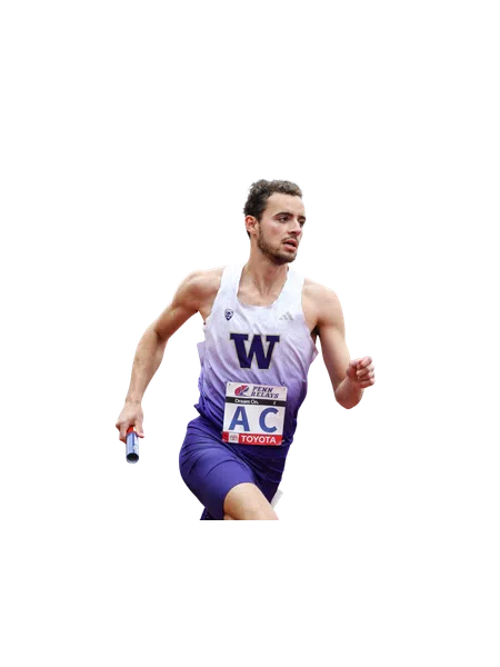 Male relay runner in purple and white uniform holding baton during a race with focused expression
