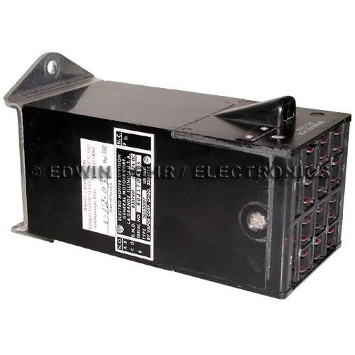 Black rectangular industrial electronic component with multiple wire connectors and identification labels attached.