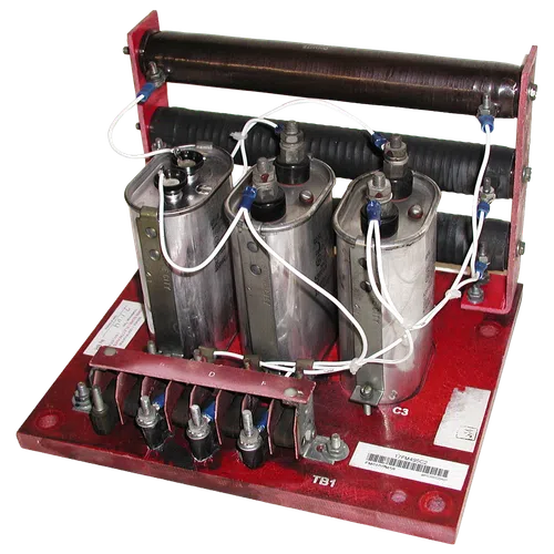 Three large capacitors connected with white wires mounted on a red base with coils and terminals for electrical testing.