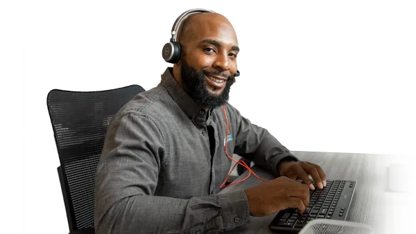 Agent at desk smiling