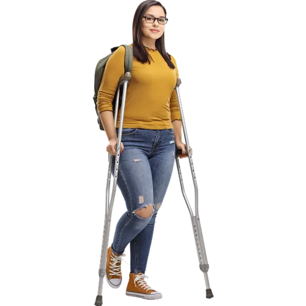 Young woman with glasses using crutches, wearing mustard sweater, ripped jeans, and orange sneakers with backpack.