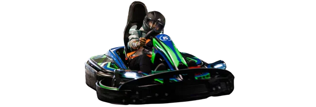 Person wearing a helmet driving a blue and green go-kart racing vehicle at speed indoors.