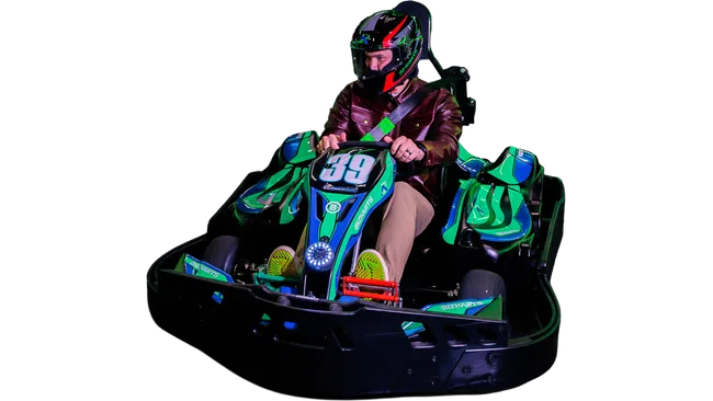 Man wearing helmet and leather jacket driving green and blue go-kart number 39 isolated on black background