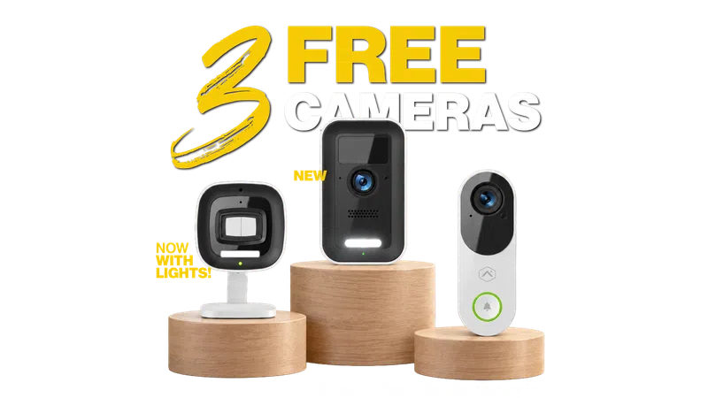 Three modern security cameras displayed on wooden stands with bold text announcing three free cameras offer.