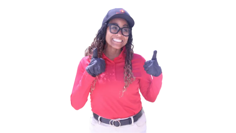 Smiling woman wearing a red shirt, black gloves, glasses, and blue cap giving two thumbs up.