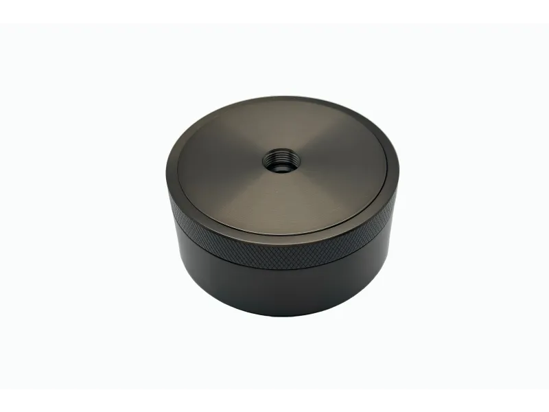 A sleek, round metallic device with a threaded center and textured sides, ideal for various applications.