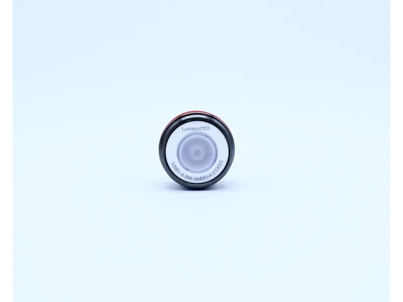 Close-up of LumienPRO LED light bulb with white and red casing on a plain white background.