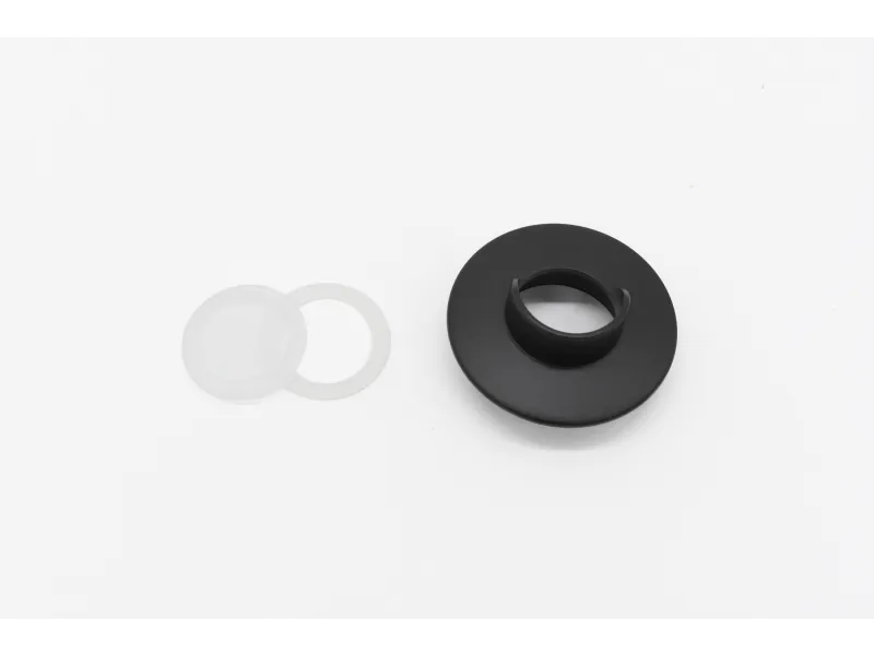 Black plastic ring with clip and two translucent silicone washers on white background