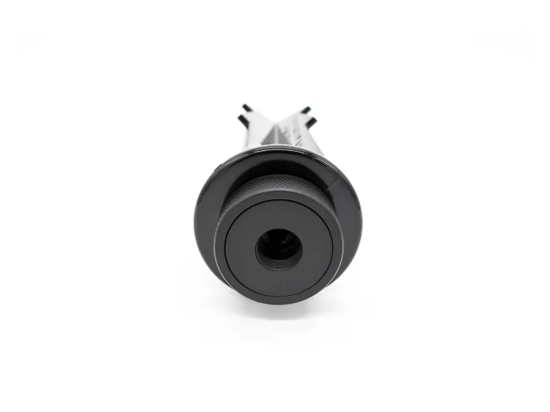 Close-up view of a black camera lens or optical device on a white background.