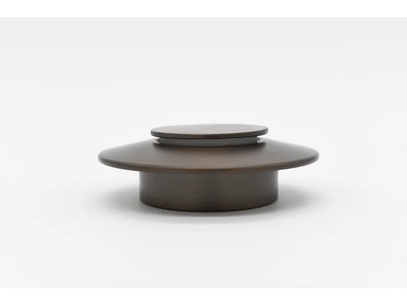 Dark brown metal furniture knob with a round flat top and wide base on a white background.