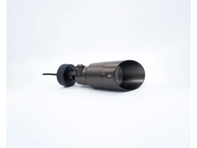 Black cylindrical object with a lens and adjustable knob on a white background, possibly a camera or optical device.